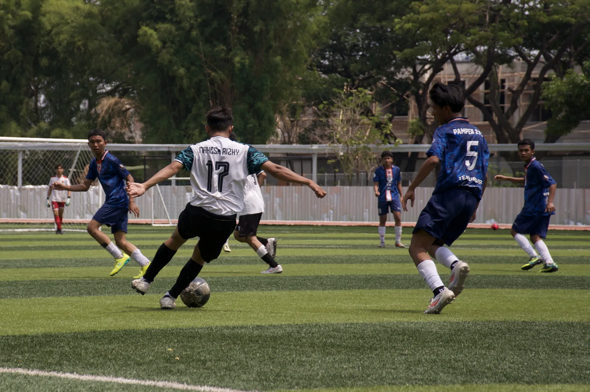 Pemain bola berencana mengoper bola ke temannya